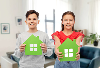 Image showing smiling little girl and boy holding green houses