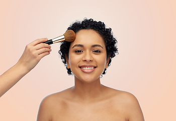 Image showing happy woman and hand of make up artist with brush