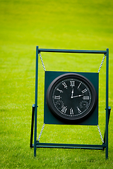 Image showing Outdoor Clock on golf course with green spring valley on the bac