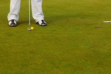 Image showing Playing golf. Golf club and ball. Preparing to shot