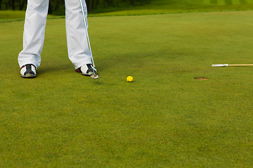 Image showing Playing golf. Golf club and ball. Preparing to shot