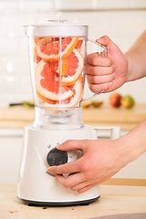 Image showing Grapefruit white Blender on a wooden table.