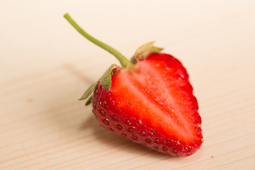 Image showing Fresh, juicy strawberries on a wood table. 