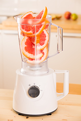 Image showing Grapefruit white Blender on a wooden table.