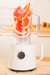 Image showing Grapefruit white Blender on a wooden table.