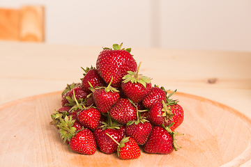 Image showing Fresh, juicy strawberries on a wood table