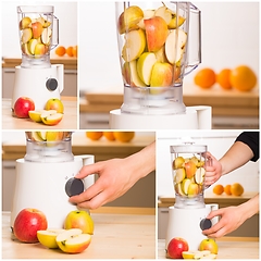 Image showing White blender with apples on a wooden table.