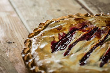 Image showing Berry pie with blueberries close-up on a plate on the table. horizontal