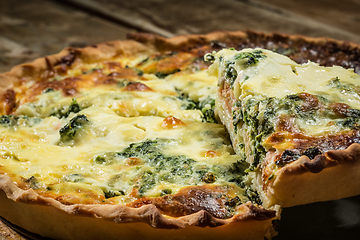 Image showing Traditional French cake. quiche with chard in white. Dark wood background. free space text.