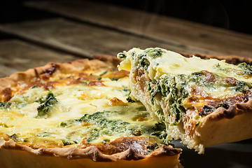 Image showing Traditional French cake. quiche with chard in white. Dark wood background. free space text.