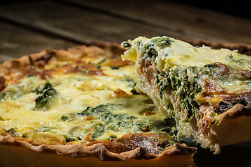 Image showing Traditional French cake. quiche with chard in white. Dark wood background. free space text.