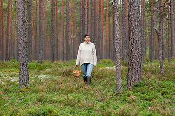 Image showing woman with basket picking mushrooms in forest