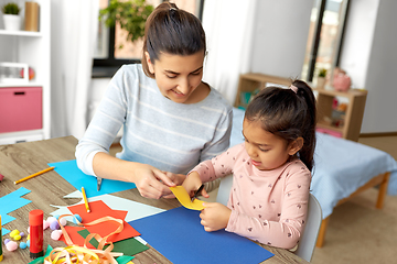 Image showing daughter with mother making applique at home