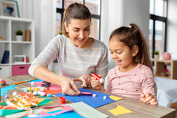 Image showing daughter with mother making applique at home