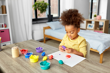 Image showing little girl with modeling clay playing at home