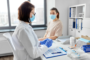 Image showing female doctor with syringe and patient at hospital