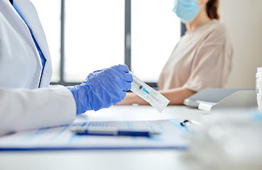 Image showing female doctor with syringe and patient at hospital