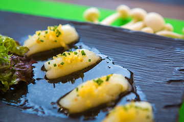 Image showing Pieces of white tuna with herbs and sauce