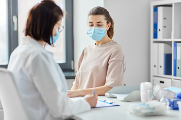 Image showing doctor with clipboard and patient at hospital