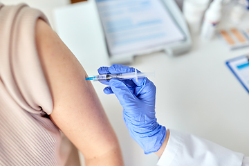 Image showing close up of hand with syringe vaccinating patient