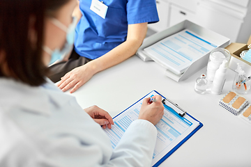 Image showing doctor with clipboard and nurse at hospital