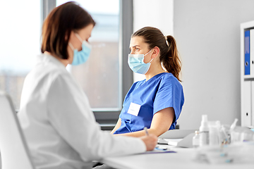 Image showing doctor with clipboard and nurse at hospital