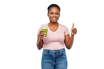 Image showing happy african american woman drinking green juice