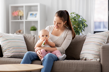 Image showing mother and little baby with teething toy at home