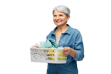 Image showing smiling senior woman with laundry basket