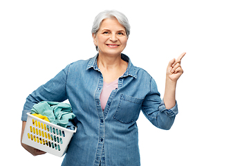 Image showing smiling senior woman with laundry basket