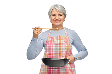 Image showing smiling senior woman in apron with frying pan