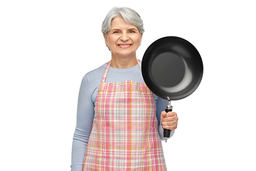 Image showing smiling senior woman in apron with frying pan