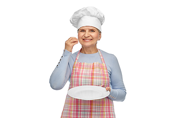 Image showing smiling senior woman or chef holding empty plate