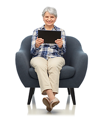 Image showing happy senior woman with tablet pc sitting in chair