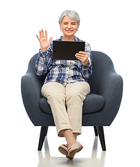 Image showing happy senior woman with tablet pc sitting in chair