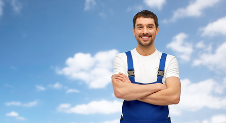 Image showing happy smiling male worker or builder in overall