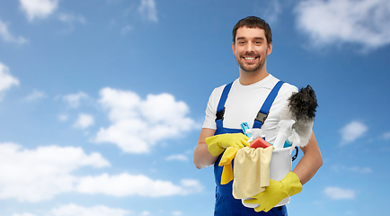 Image showing male cleaner in overall with cleaning supplies