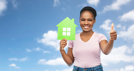 Image showing smiling african american woman holding green house