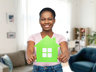 Image showing smiling african american woman holding green house