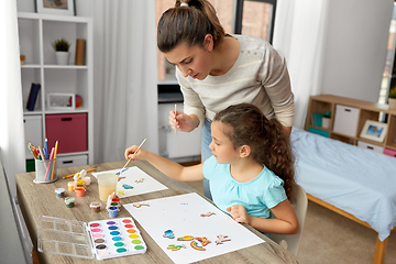 Image showing mother with little daughter drawing at home