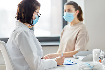 Image showing doctor with clipboard and patient at hospital