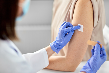 Image showing close up of doctor attaching patch to patient