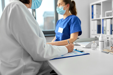 Image showing doctor with clipboard and nurse at hospital