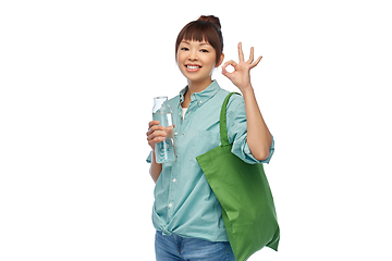 Image showing woman with bag for food shopping and glass bottle