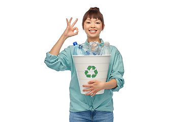 Image showing smiling young asian woman sorting plastic waste