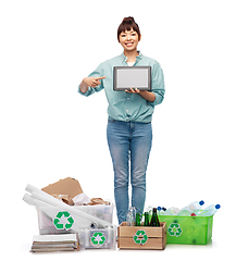 Image showing smiling asian woman with tablet pc sorting waste