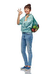 Image showing happy asian woman with food in reusable string bag