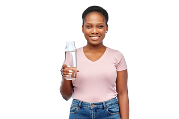 Image showing happy african woman drinks water from glass bottle