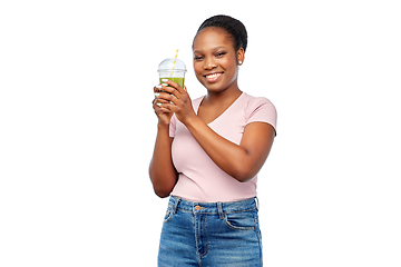 Image showing happy african american woman drinking green juice