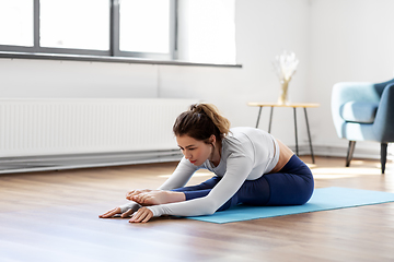 Image showing young woman doing yoga exercise at home